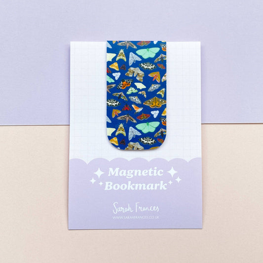 Magnetic bookmark with a moth pattern on a matching card, on a light purple background
