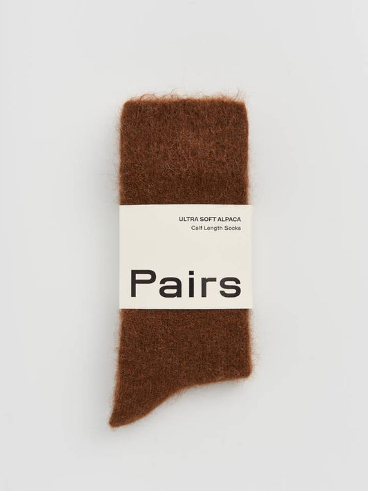 Brown sock with a 'Pairs' label on a light gray background