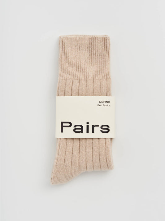 Beige sock with 'Pairs' label on a light gray background