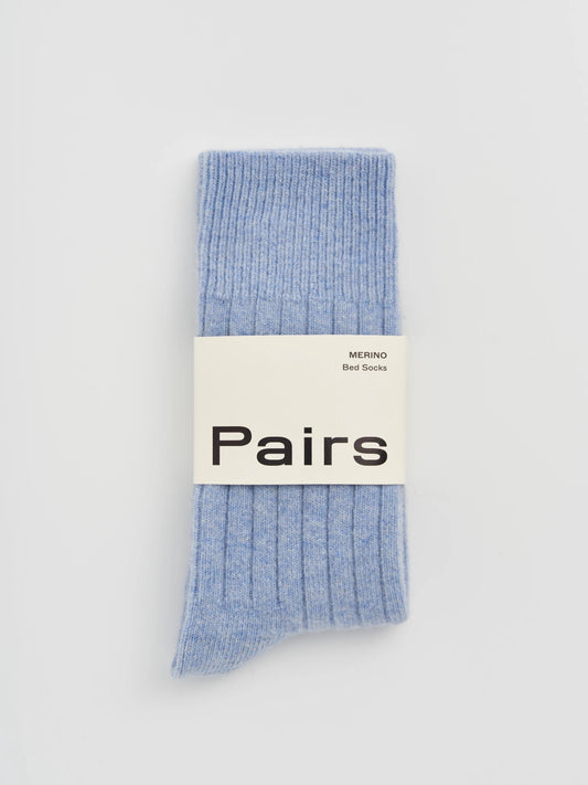 Light blue socks with a 'Pairs' label on a light gray background