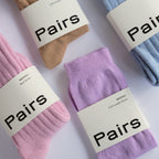 collection of pairs socks in different colours and natural fibres