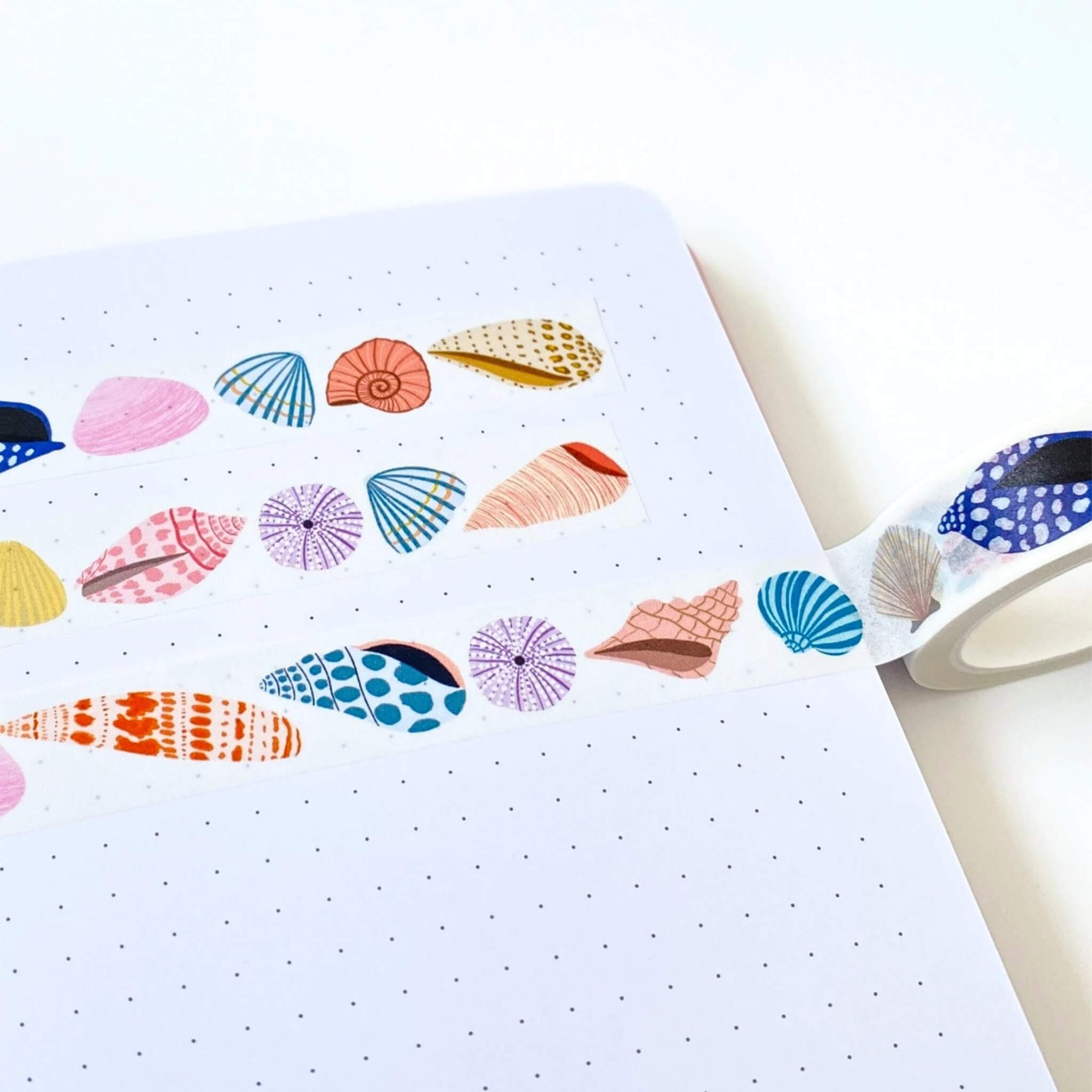 seashell washi tape design on a white dotted notebook page