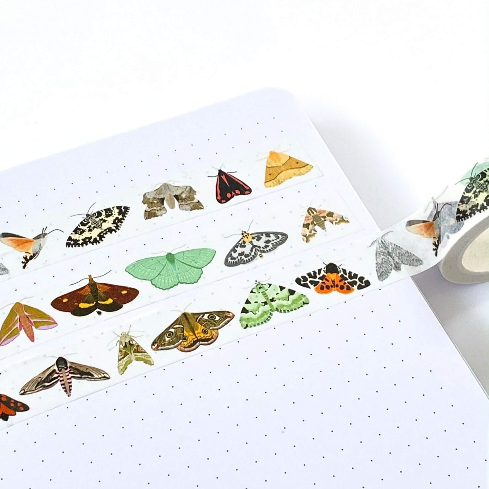 colourful moths on washi tape on a notebook page
