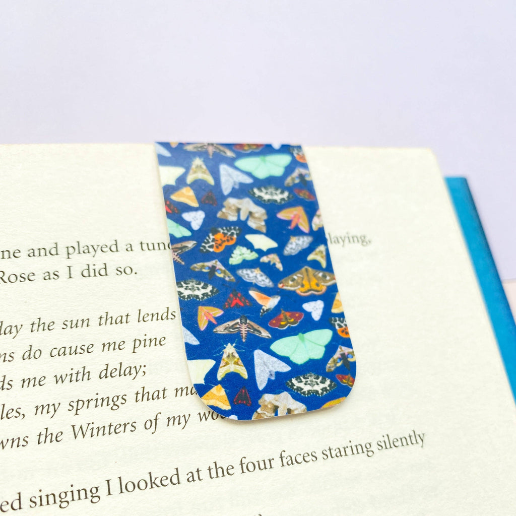 Moth magnetic bookmark with navy blue background and illustrated moths