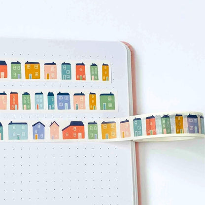 Notebook with colorful house stickers on a white background