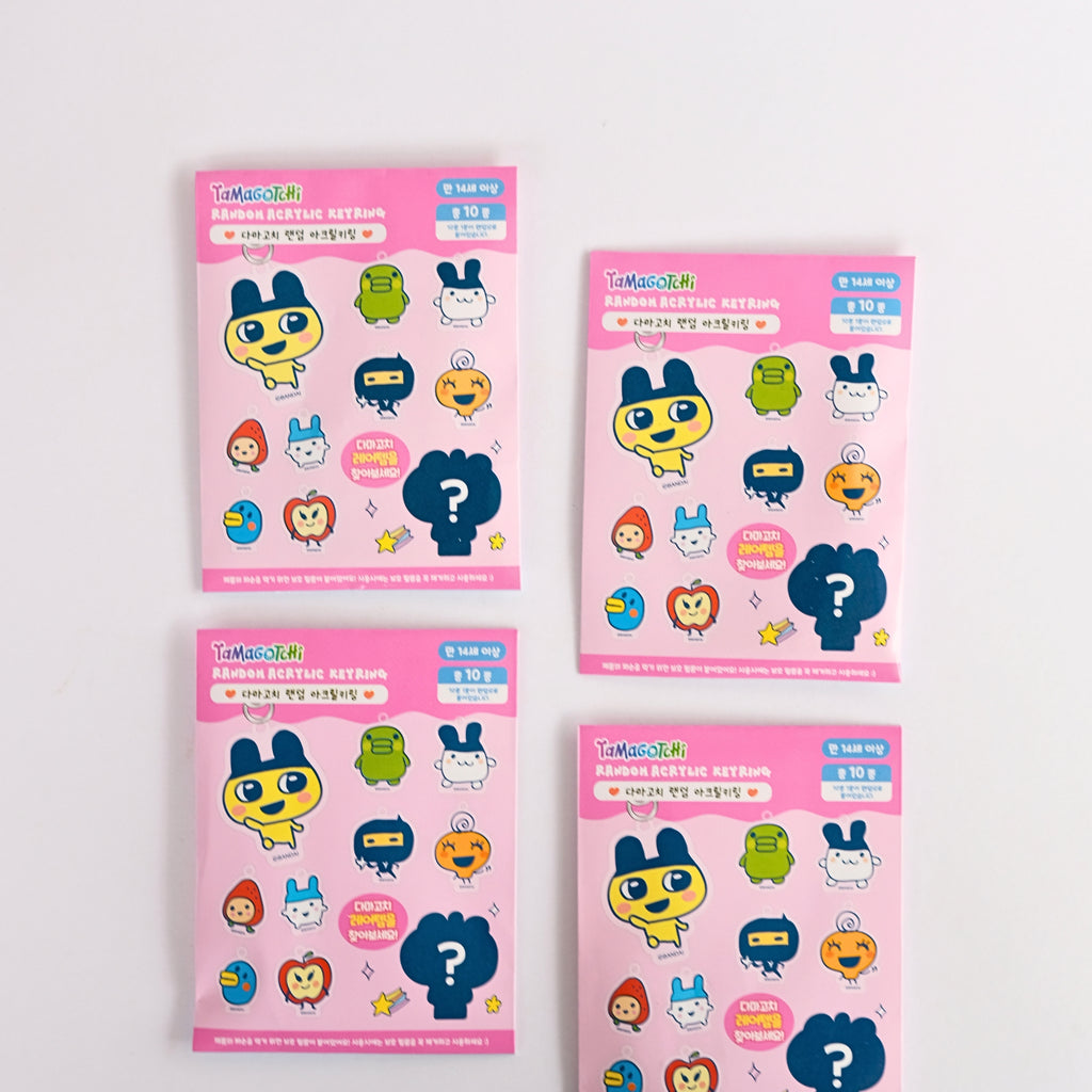 Four packages of Tamagotchi character keyrings on light gray background