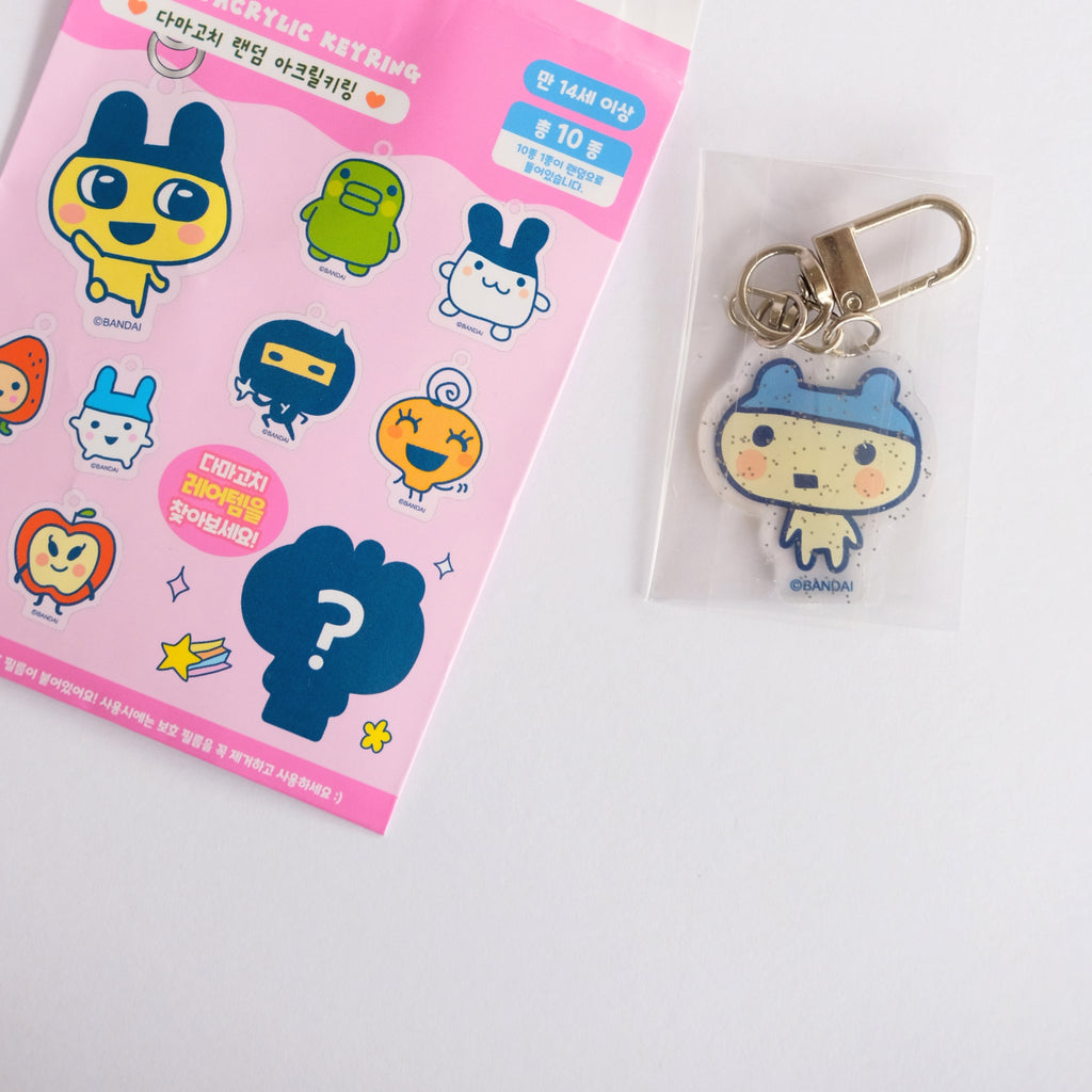 tamagotchi character keychain with packaging on a white background