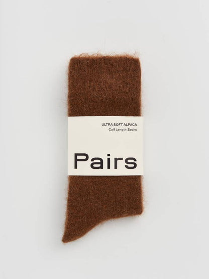 Brown sock with a 'Pairs' label on a light gray background