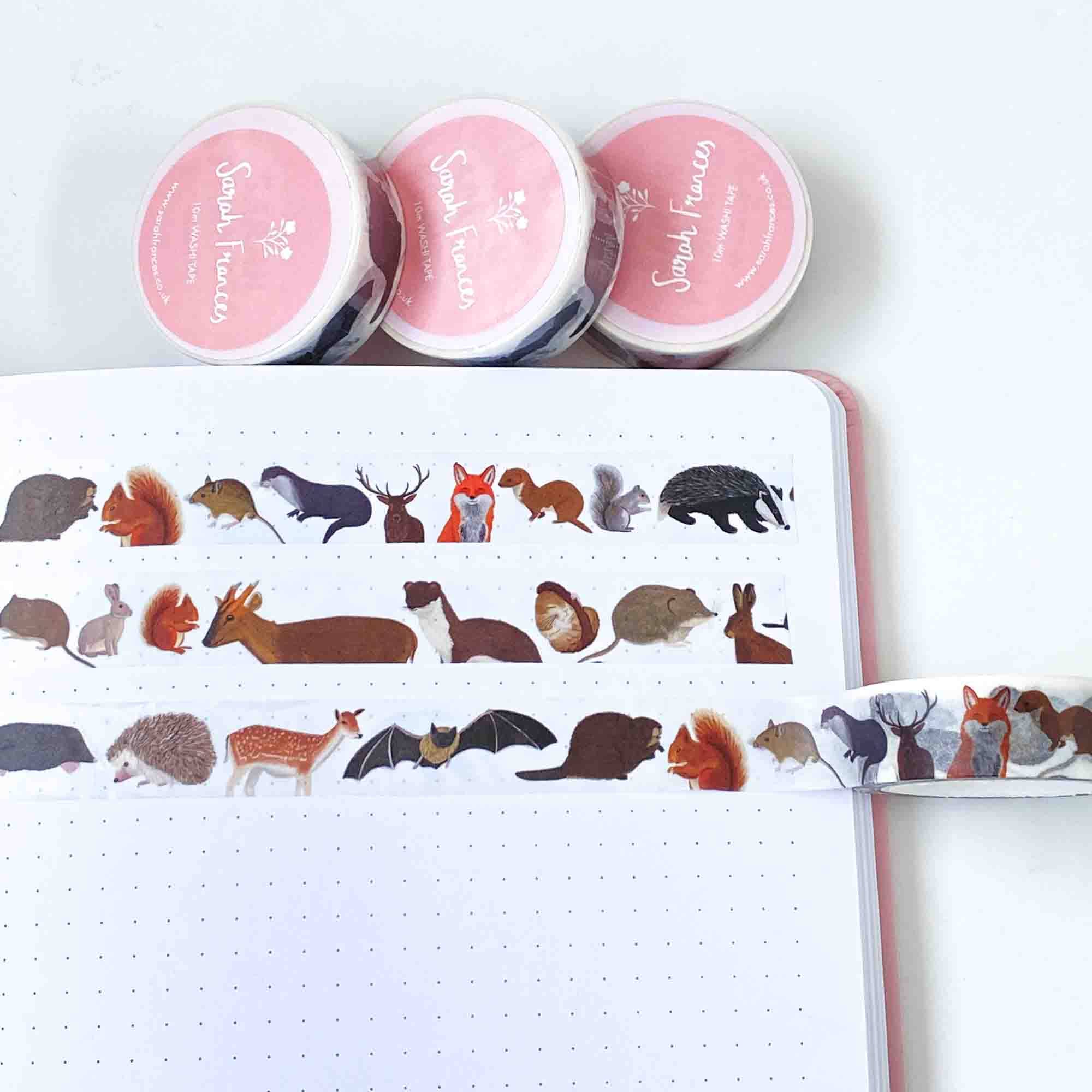 Washi tape with animal designs on a notebook