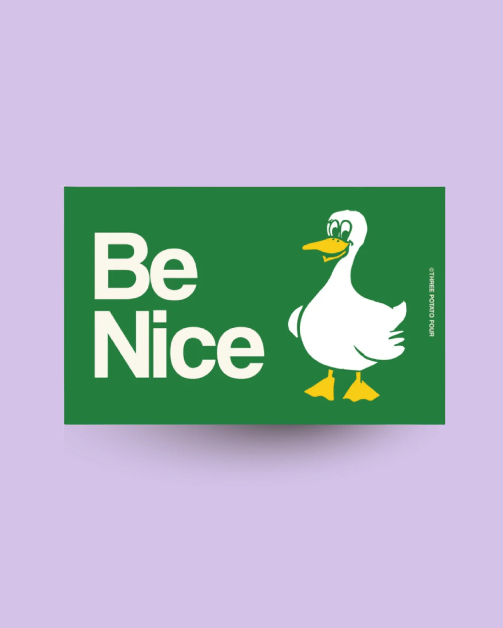 Green sign with a duck illustration and 'Be Nice' text on a purple background
