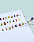 colourful beetle washi tape design on a white notebook page