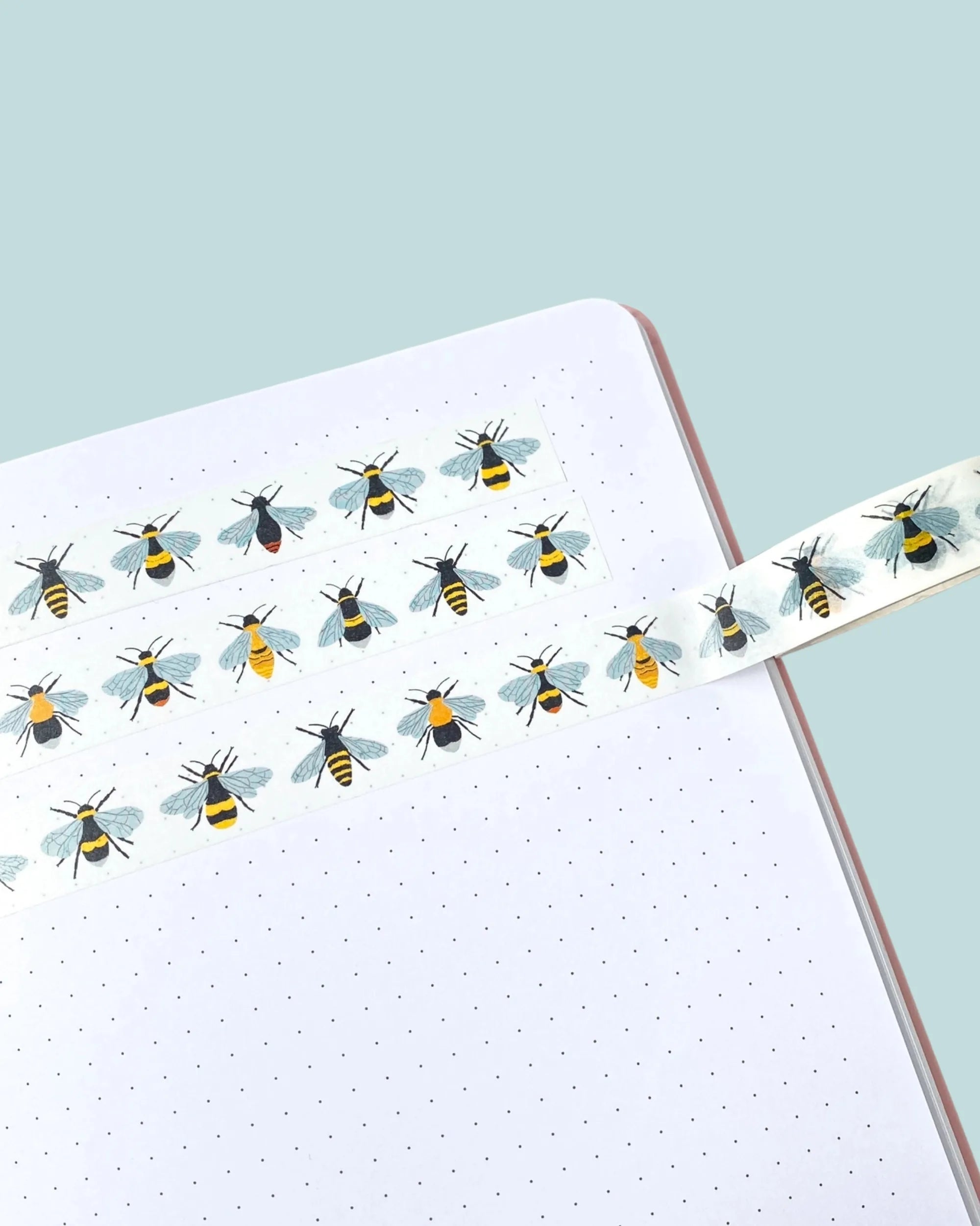 washi tape design with british bees stuck on notebook paper