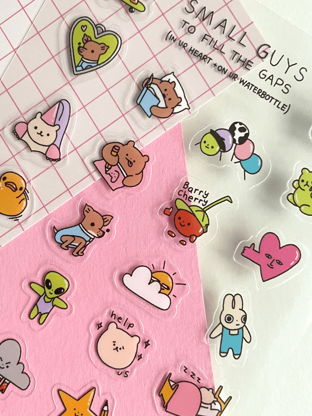 Collection of colorful cartoon stickers on a pink and white grid background