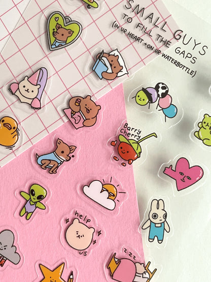 Collection of colorful cartoon stickers on a pink and white grid background