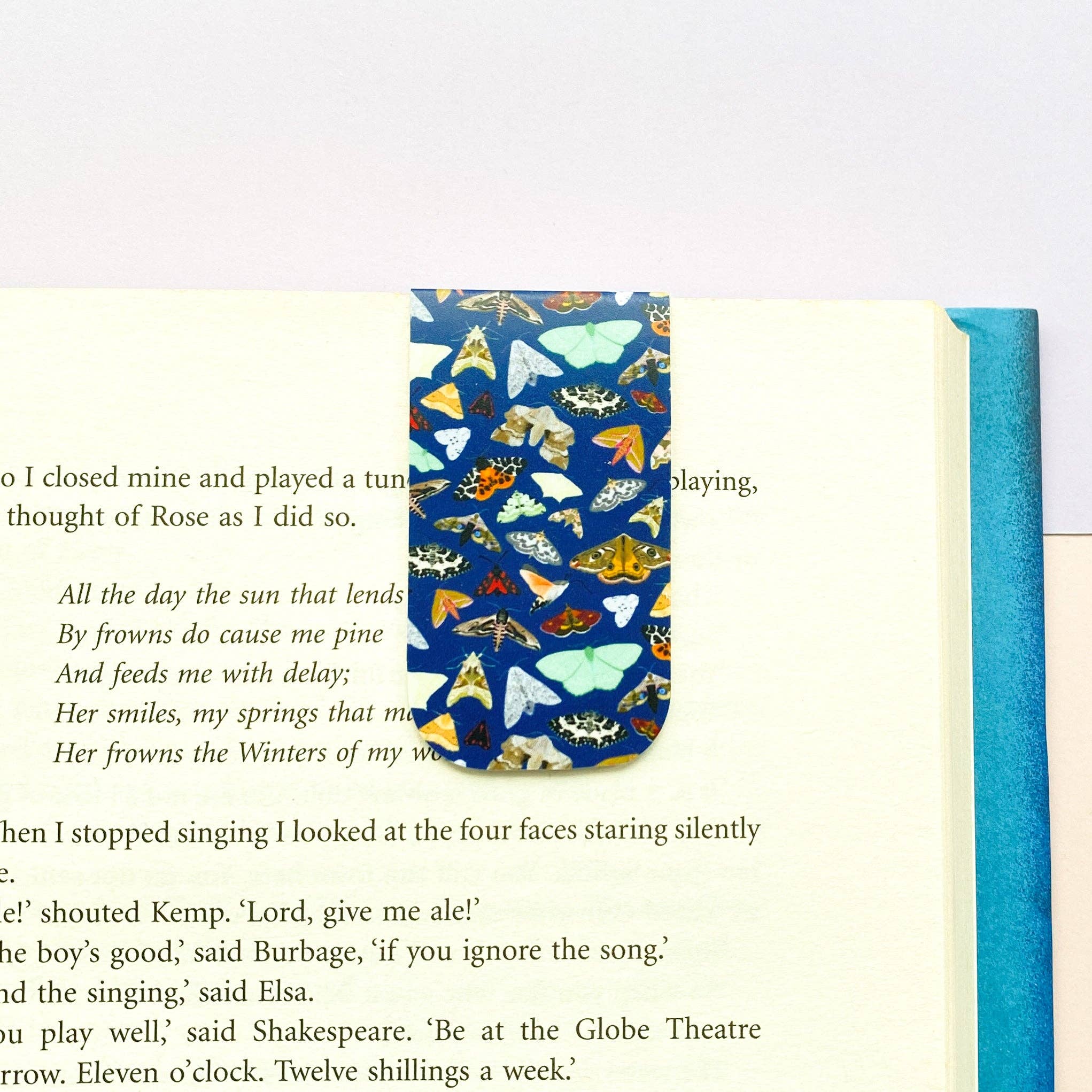 Book with a colourful moth pattern on a white background