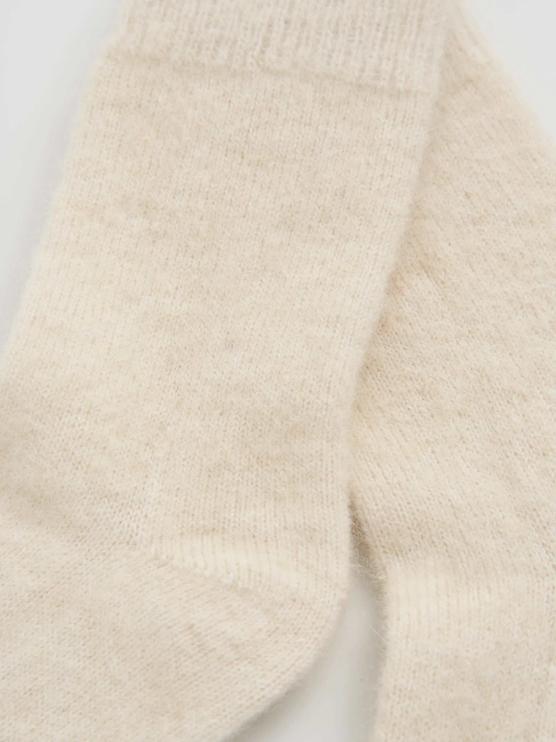 close up of cream alpaca socks 