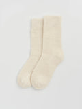 Pair of cream alpaca socks on a light gray background