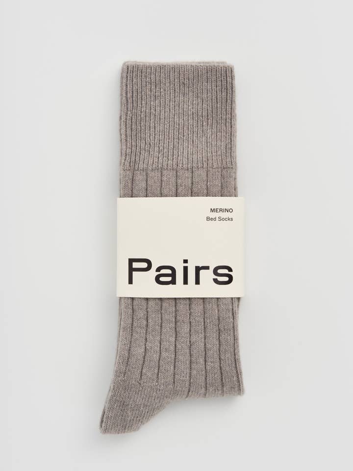 Gray sock with 'Pairs' label on a light gray background