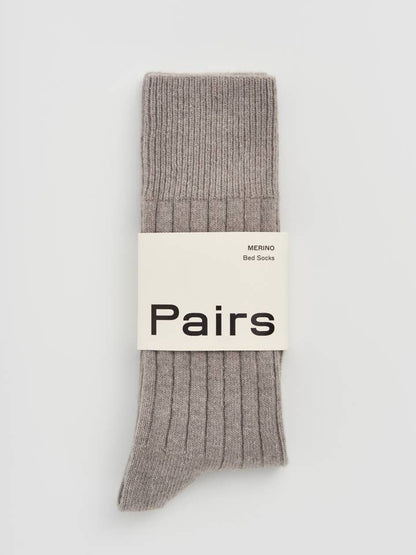 Gray sock with 'Pairs' label on a light gray background