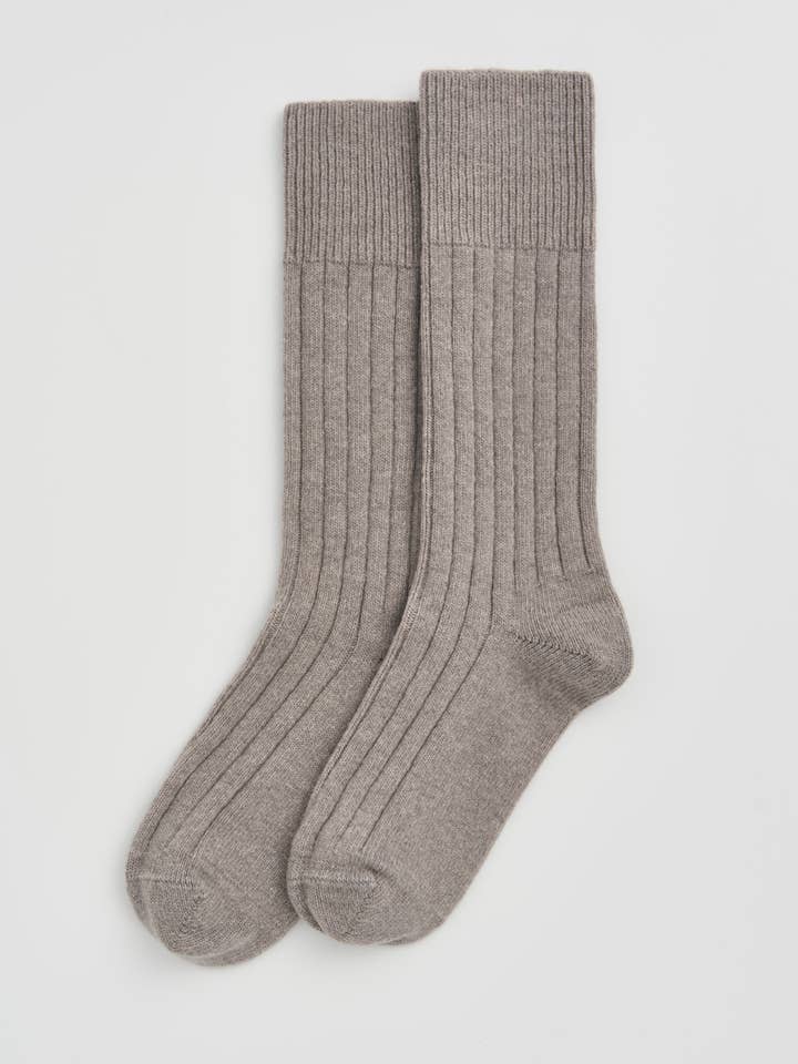 Pair of gray socks on a light gray background