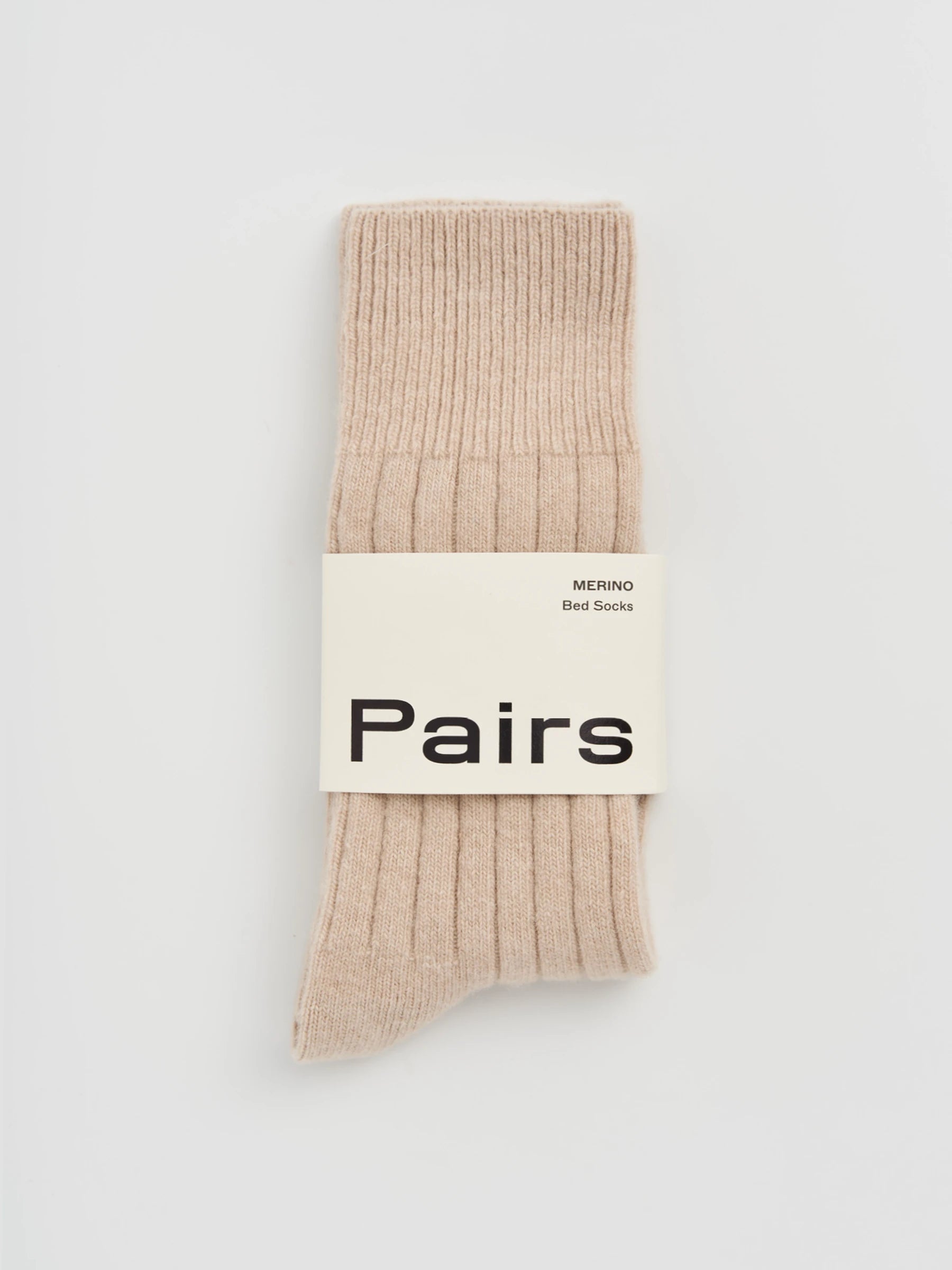 Beige sock with 'Pairs' label on a light gray background