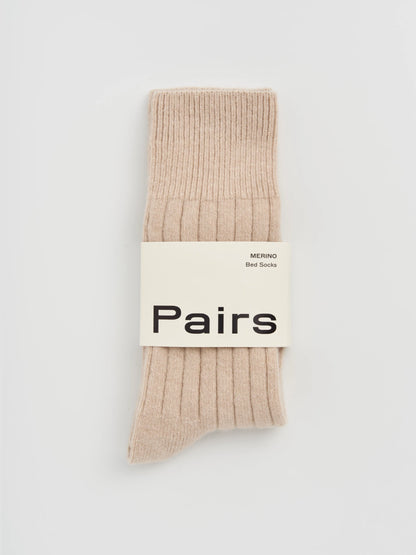 Beige sock with 'Pairs' label on a light gray background