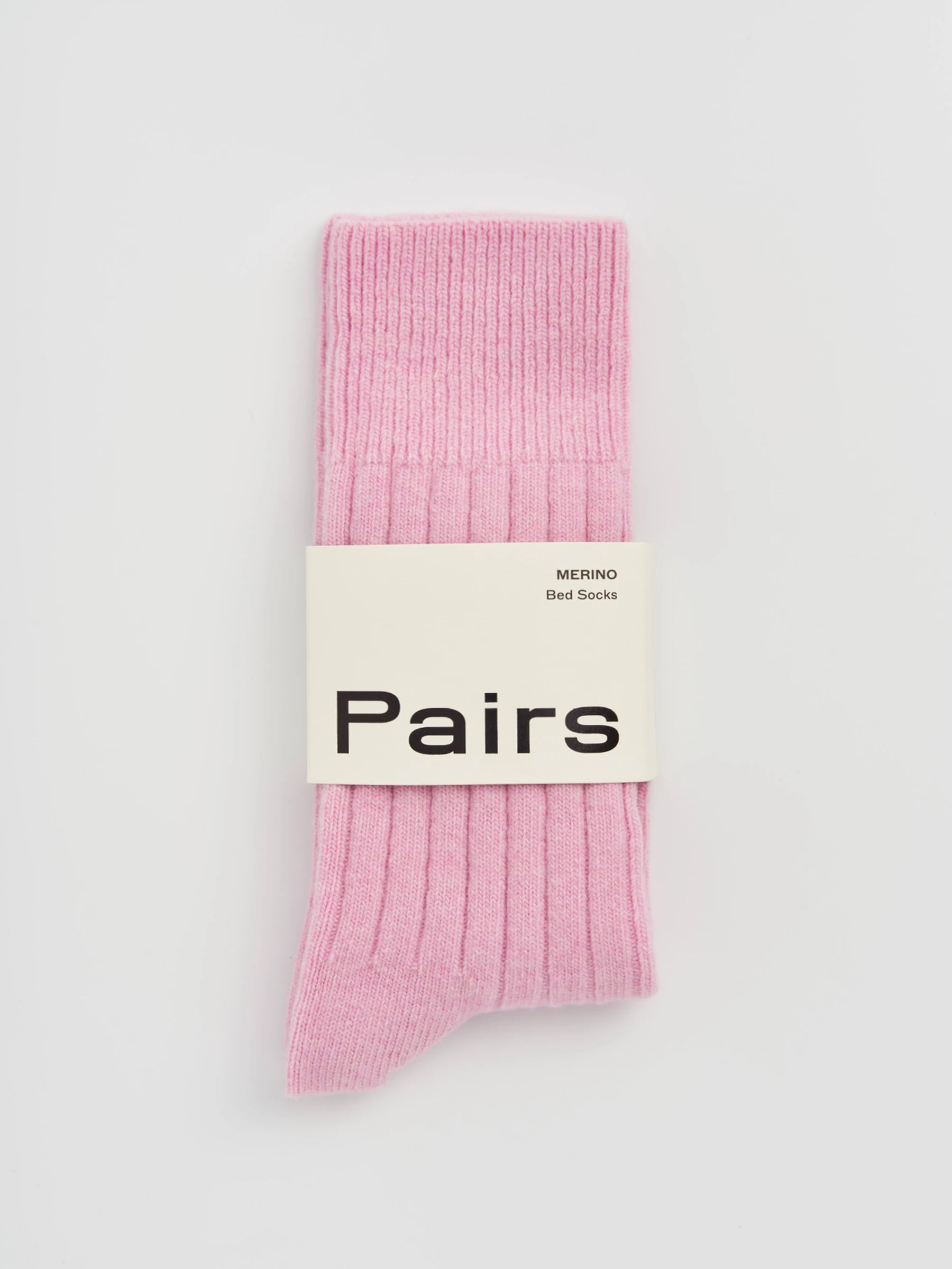 Pink socks with a 'Pairs' label on a light gray background