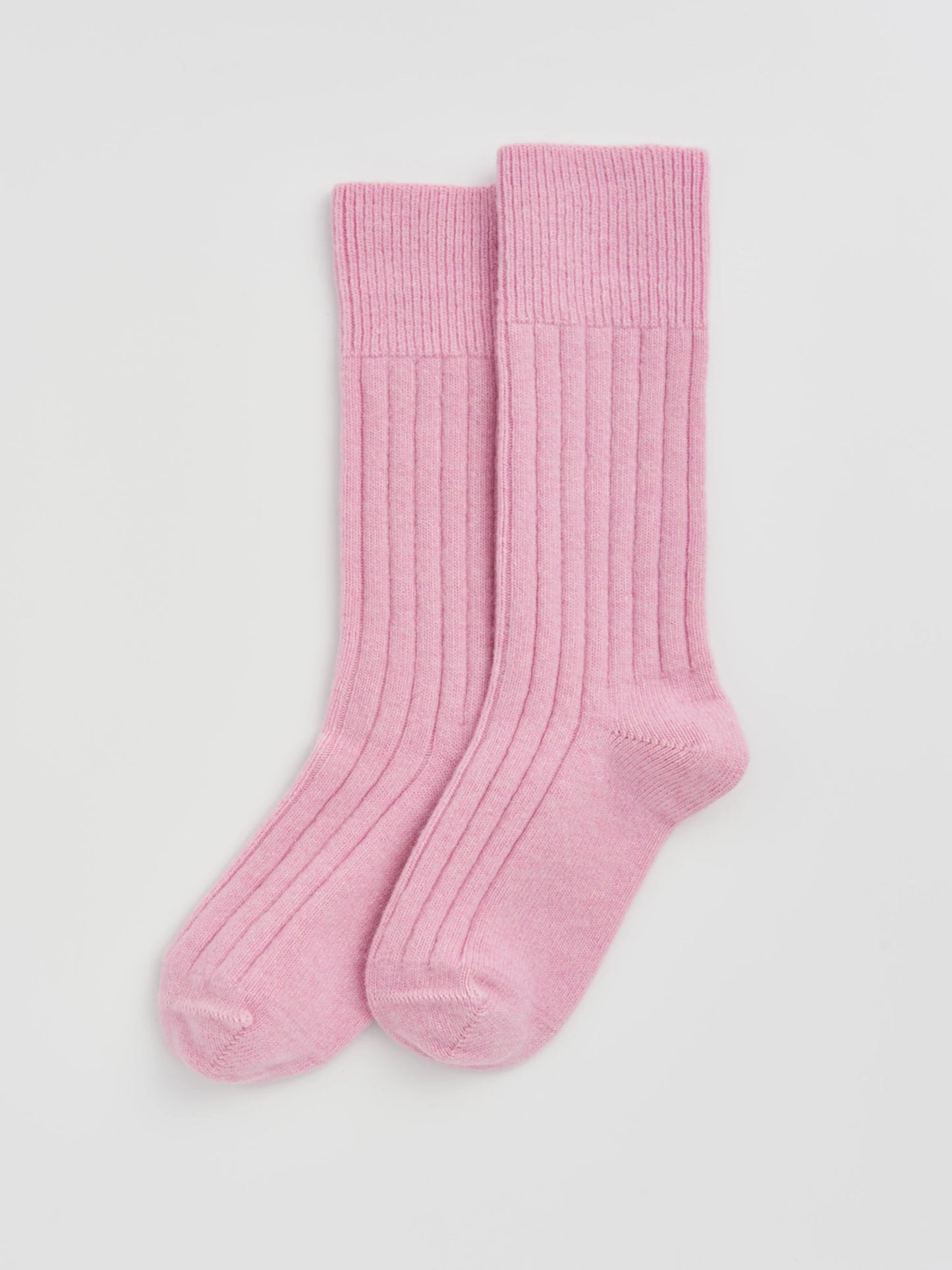 Pair of pink socks on a light gray background