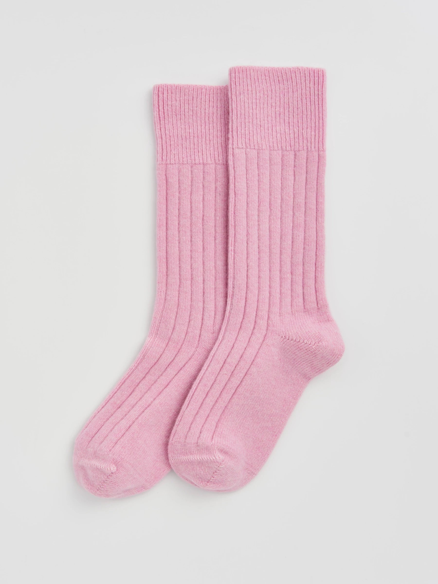 Pair of pink socks on a light gray background