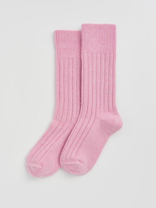 Pair of pink socks on a light gray background