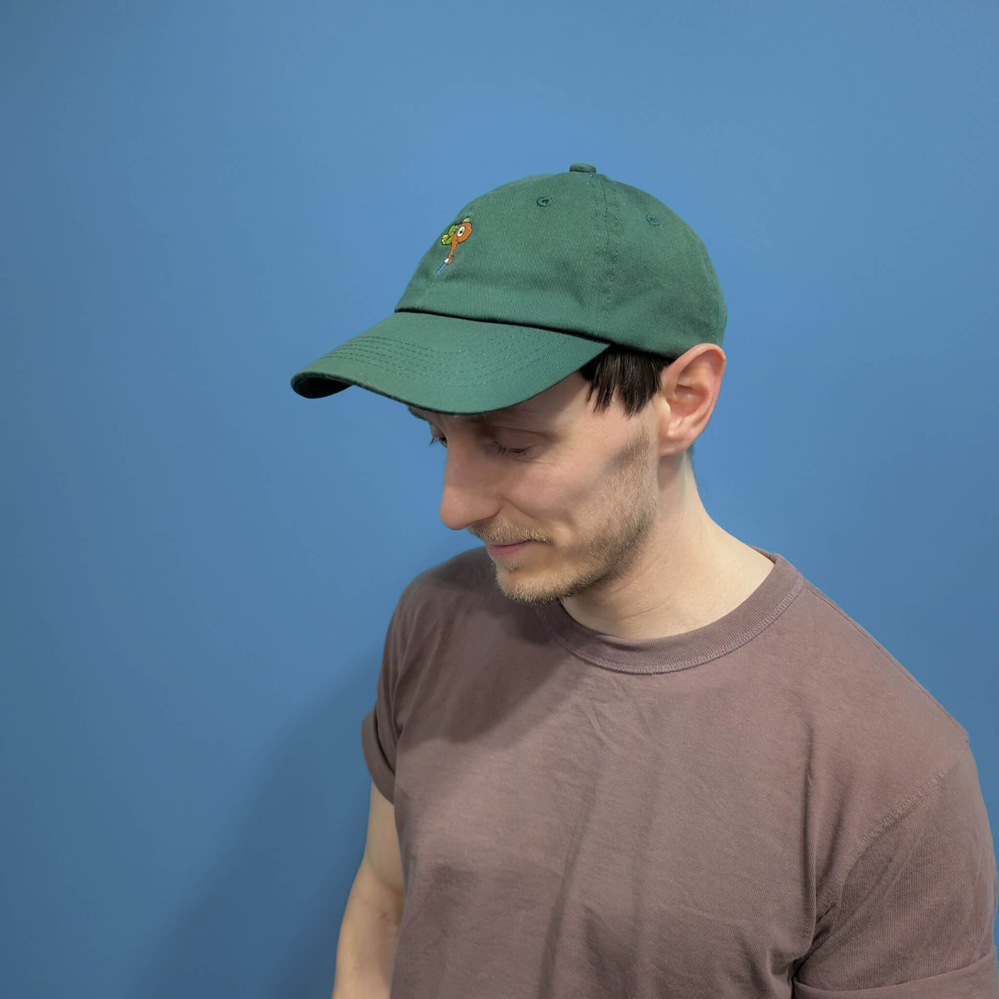 model looking down whilst wearing richard scarry dad hat