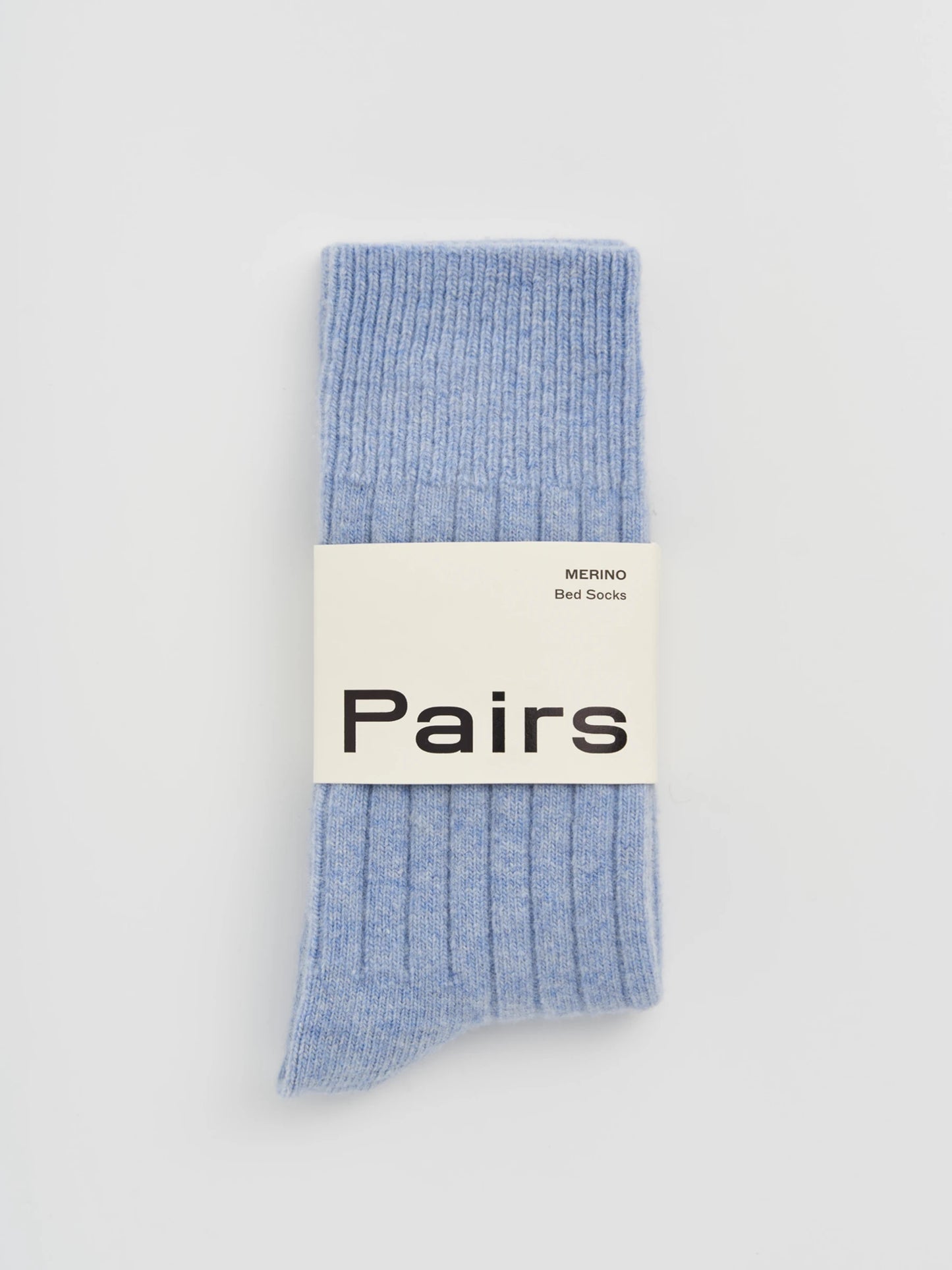Light blue socks with a 'Pairs' label on a light gray background