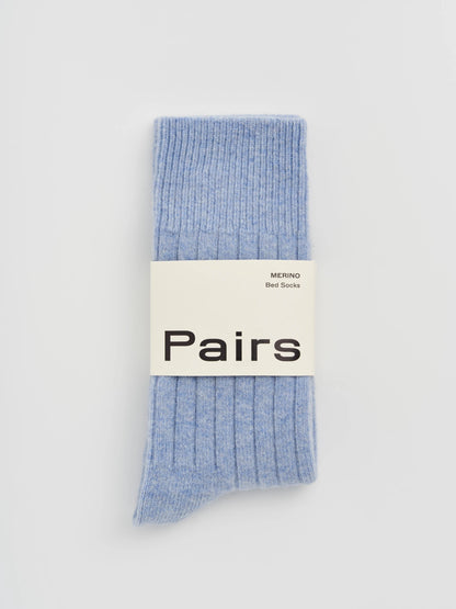 Light blue socks with a 'Pairs' label on a light gray background