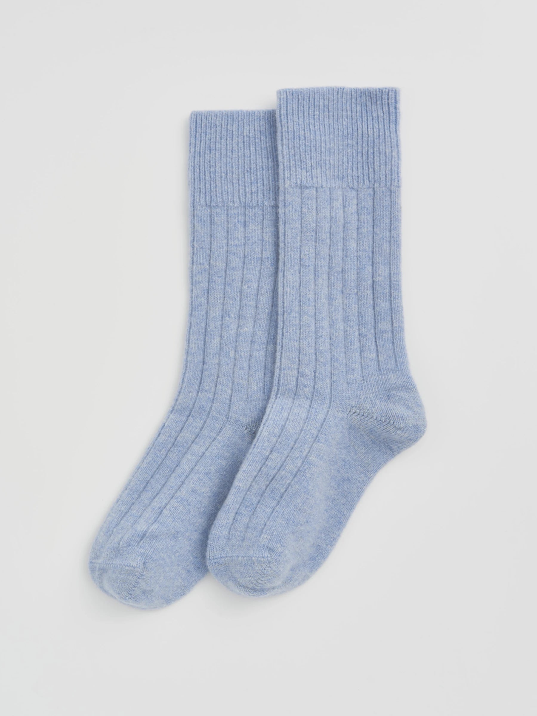 Pair of light blue socks on a white background