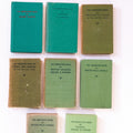 Collection of vintage green books on a white background