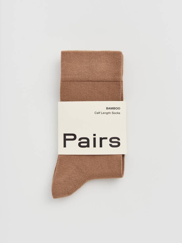 Brown sock with a 'Pairs' label on a light gray background