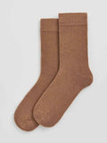 Pair of brown socks on a light gray background