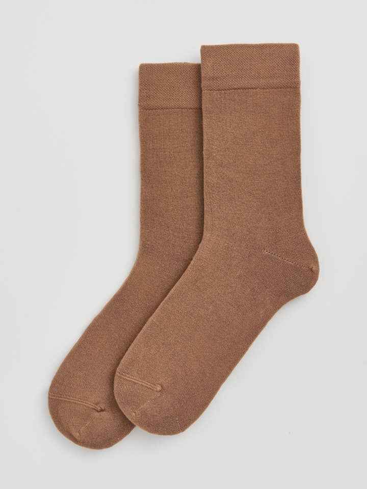 Pair of brown socks on a light gray background