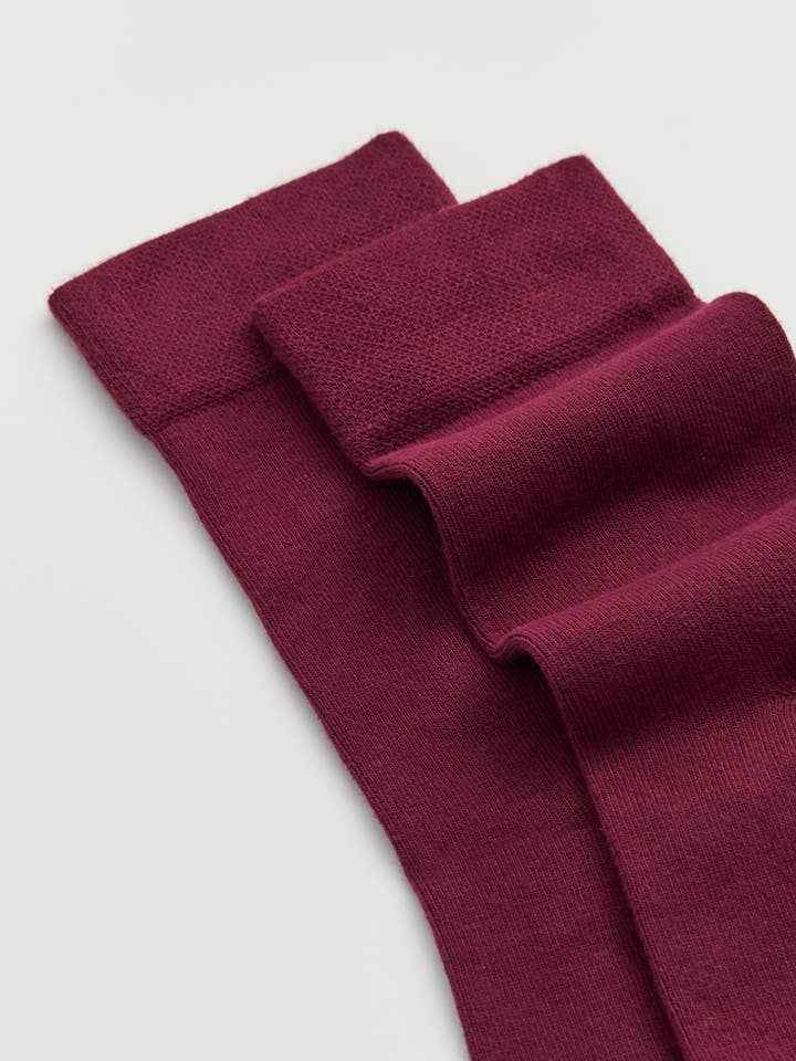 Maroon bamboo socks on a light gray background