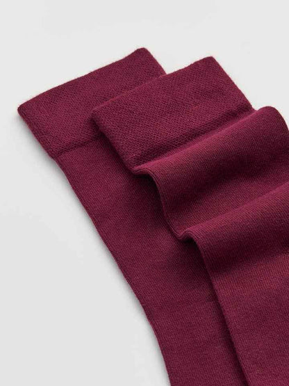 Maroon bamboo socks on a light gray background