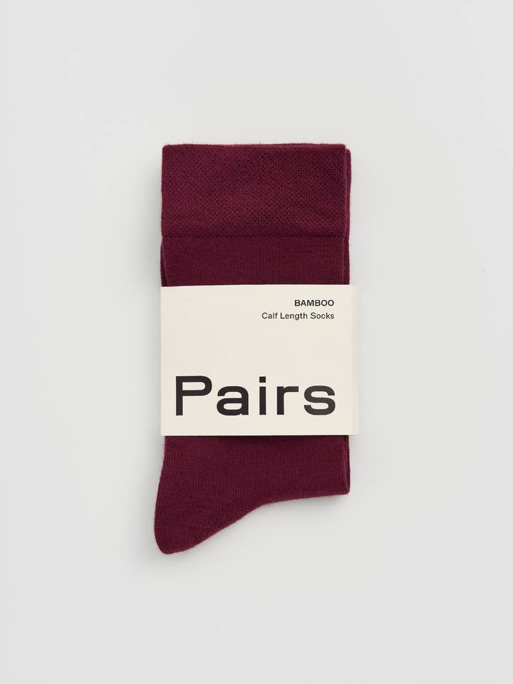 Burgundy sock with 'Pairs' label on a light gray background