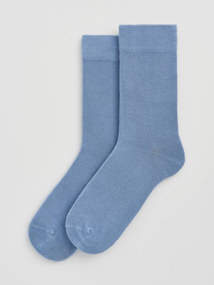 Pair of light blue socks on a white background