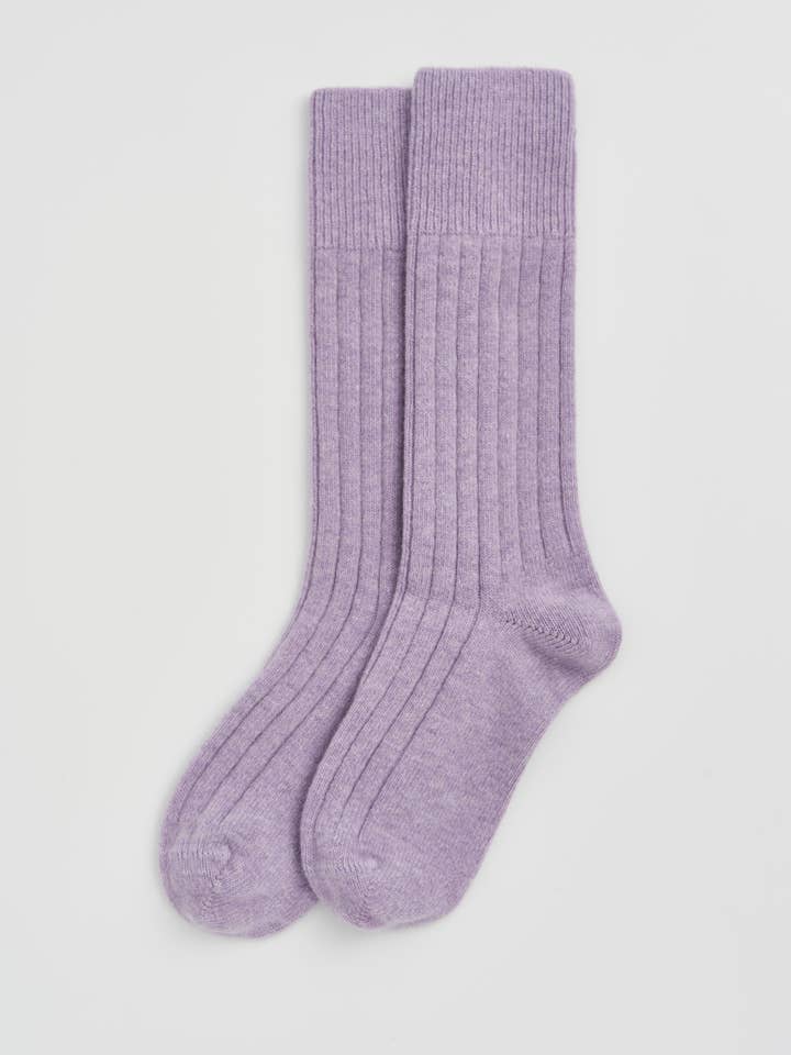 Pair of purple socks on a light gray background