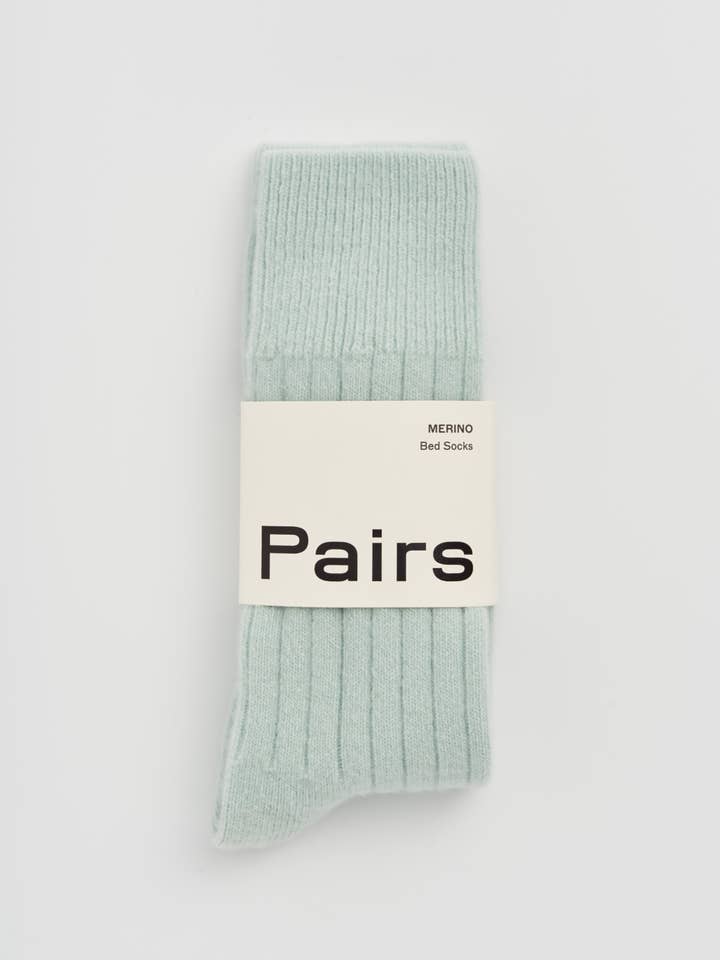 Light green sock with 'Pairs' label on a white background