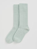 Pair of light green wool socks on a white background