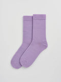 Pair of purple socks on a light gray background