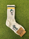 White sock with a snoopy character on a green textured background