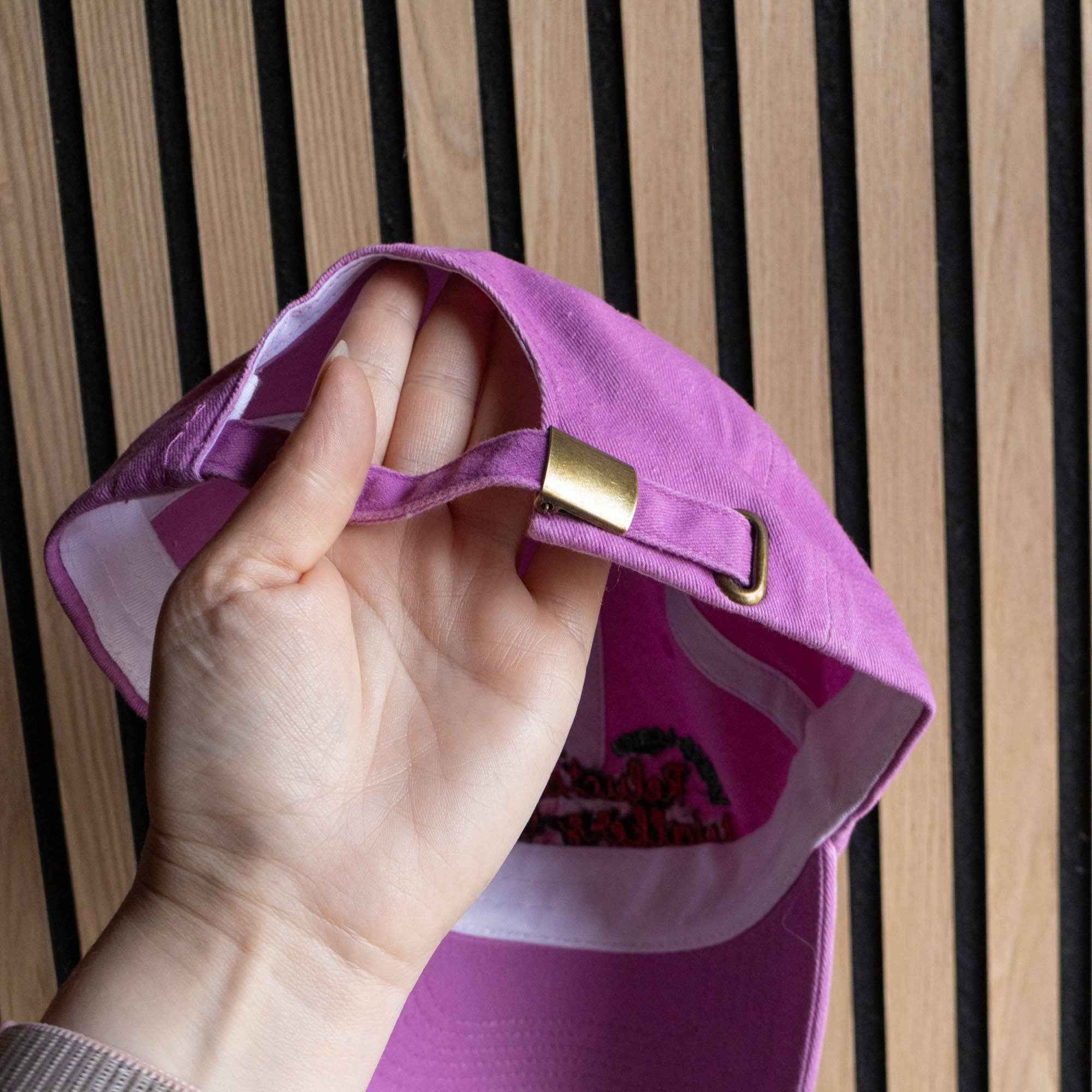 Vintage washed baseball cap with bright embroidery and adjustable strap.