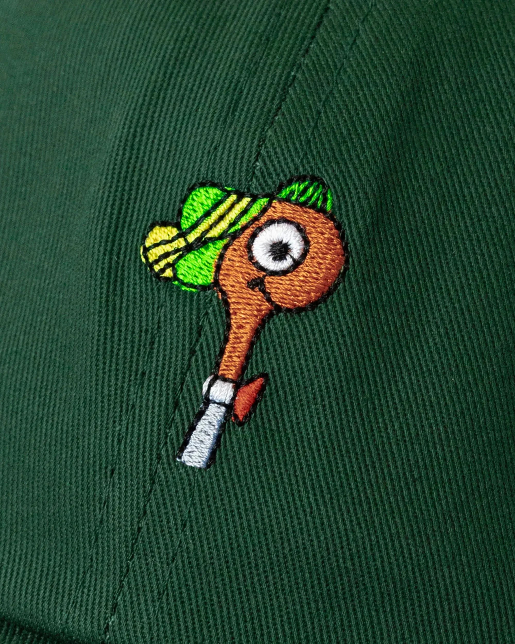 Embroidered design of lowly worm wearing a hat on a green background