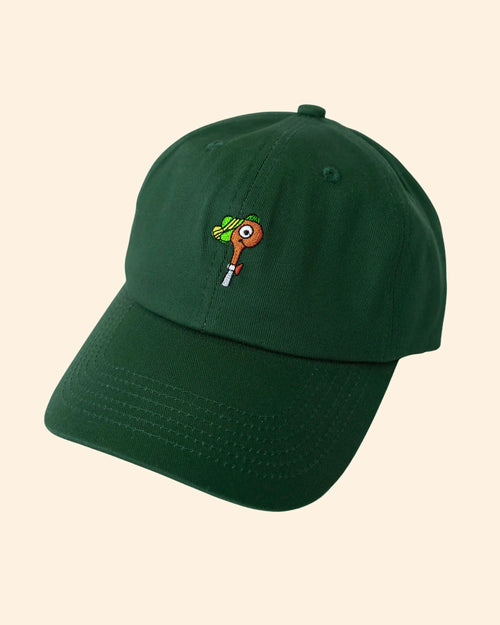 Green cap with a small embroidered lowly worm on a beige background